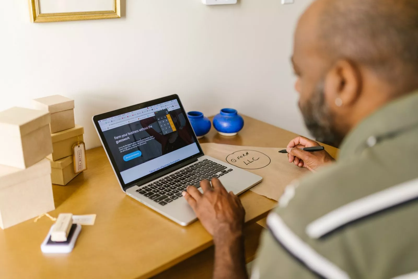 Small business owner working at a laptop in a modern office, reviewing ransomware protection and IT security planning